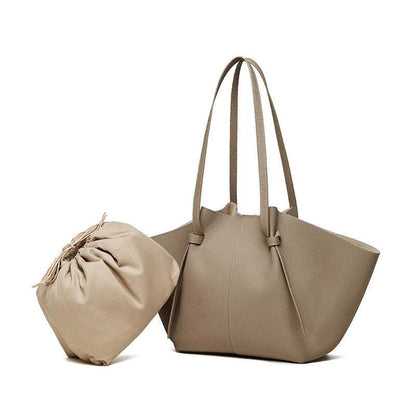 Modern leather work tote with removable interior drawstring bag, featuring distinctive pleated straps.