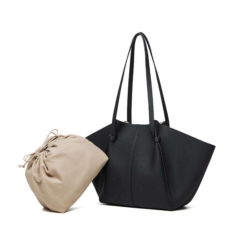 Black leather work tote with removable drawstring bag and pleated straps.