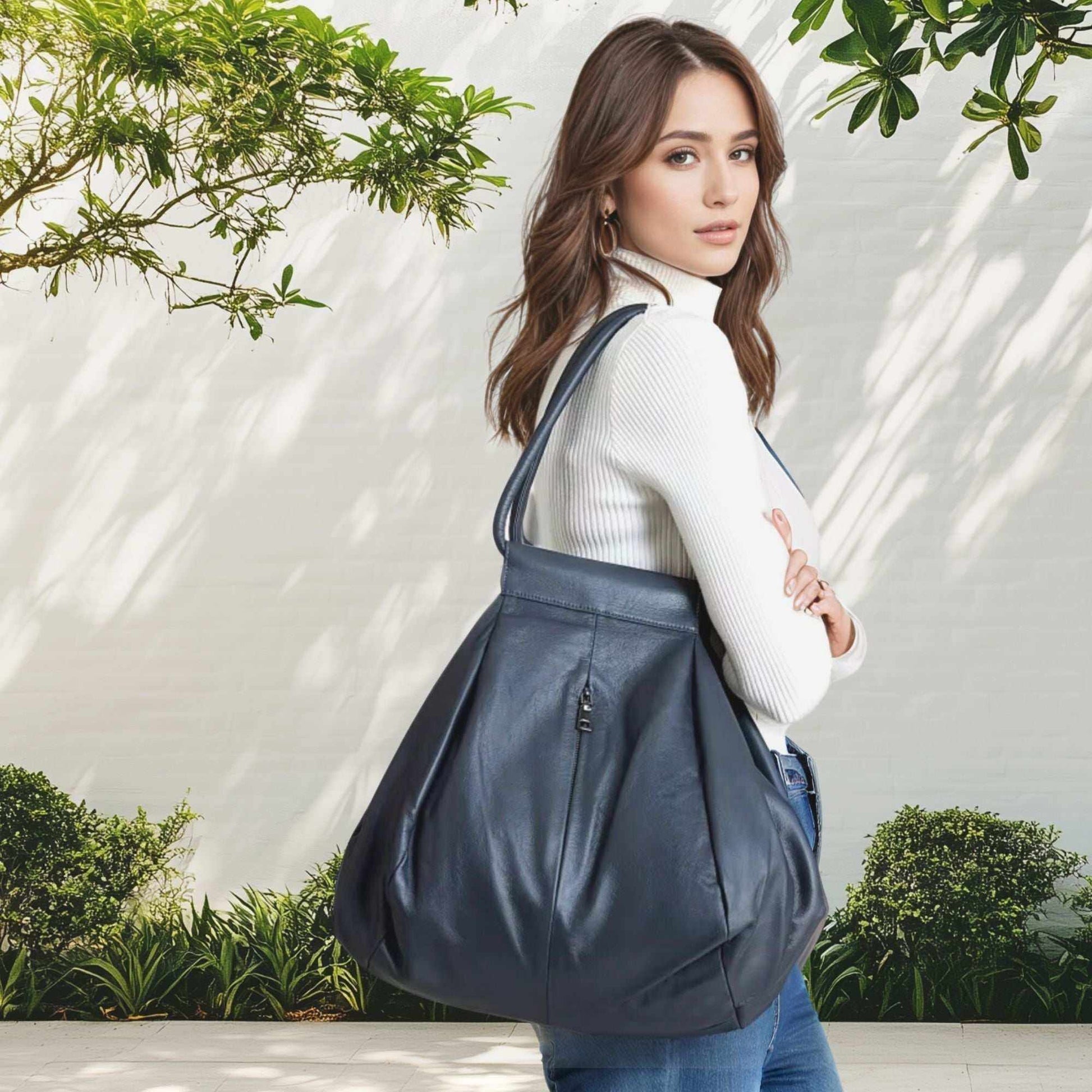 Genuine slouchy leather bag worn by woman in outdoor setting.