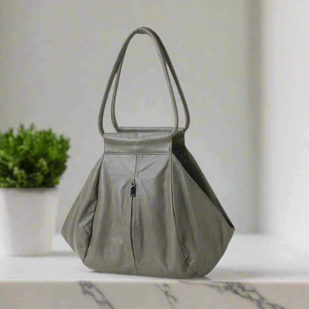 Slouchy Leather Bag in Elephant Gray on a marble surface.