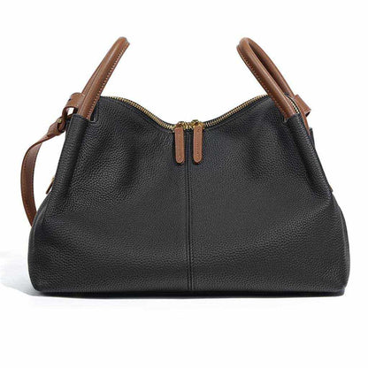 Soft leather crossbody bag with dual handles in black, featuring a zippered top and brown accents.