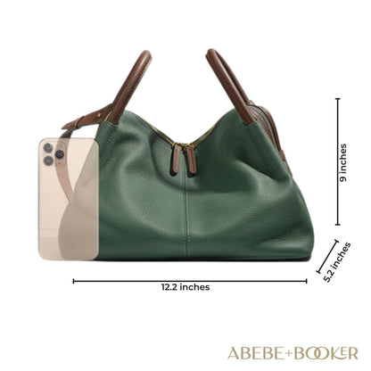 Soft leather crossbody bag in green, measuring 12.2 x 5.1 x 9.1 inches, with dual brown handles and stylish design.