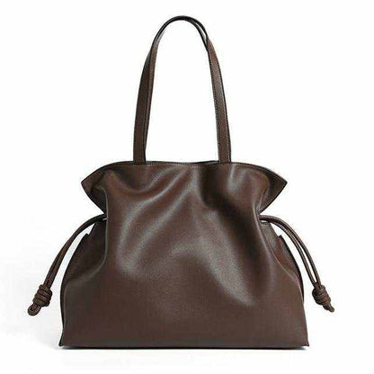 Soft Leather Tote with drawstring closure, elegant design, and genuine leather material.