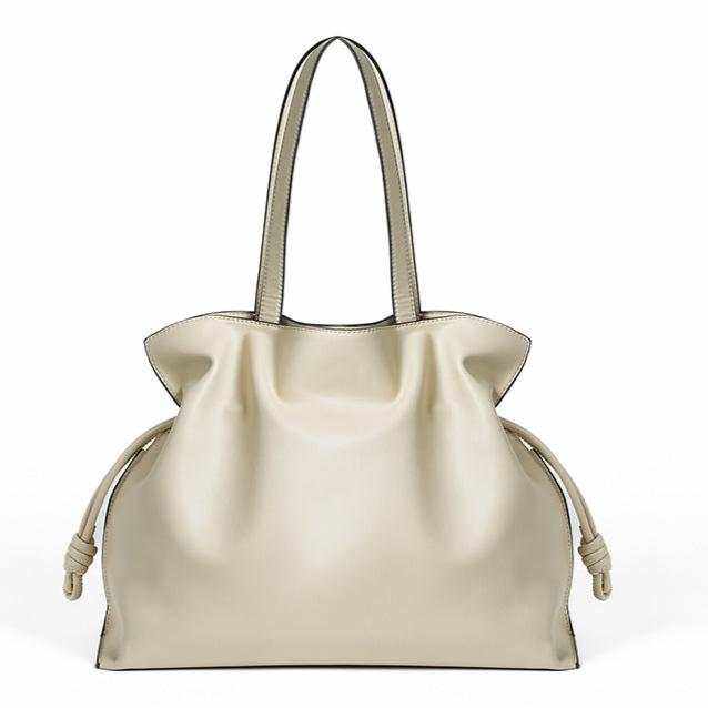 Elegant soft leather tote bag with pleated exterior and drawstring closure.