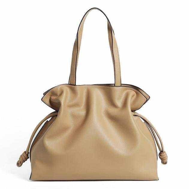 Beige soft leather tote bag with pleated exterior and drawstring detail.