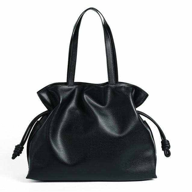 Black soft leather tote bag with drawstring closure and handles, featuring a sleek and minimalist design.