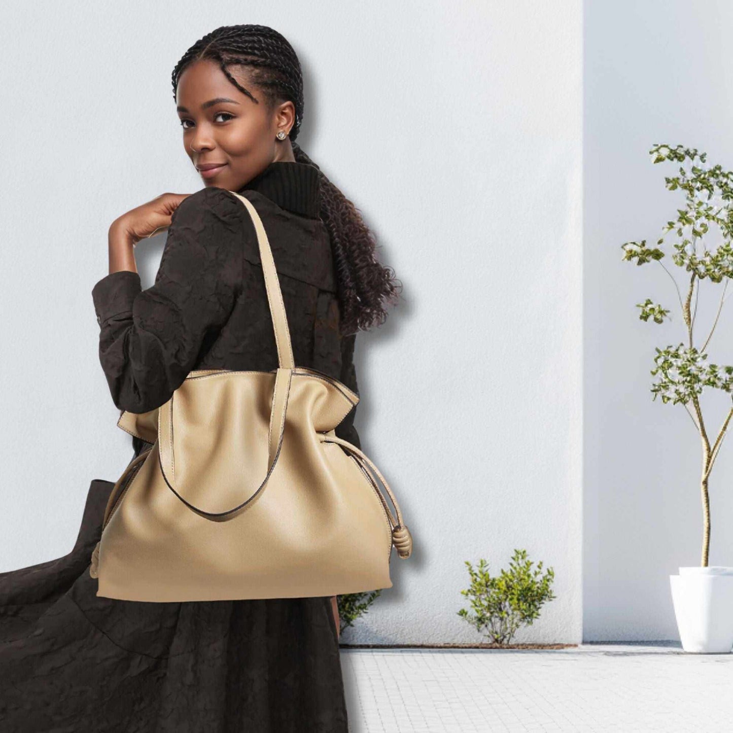 Elegant woman carrying Soft Leather Tote in beige, showcasing sophisticated and functional design.