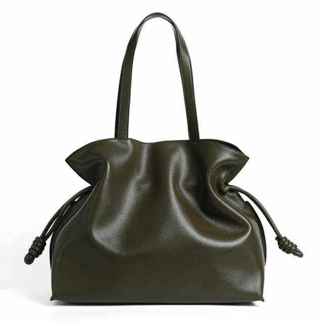 Elegant soft leather tote featuring a minimalist design and drawstring closure, perfect for any occasion.