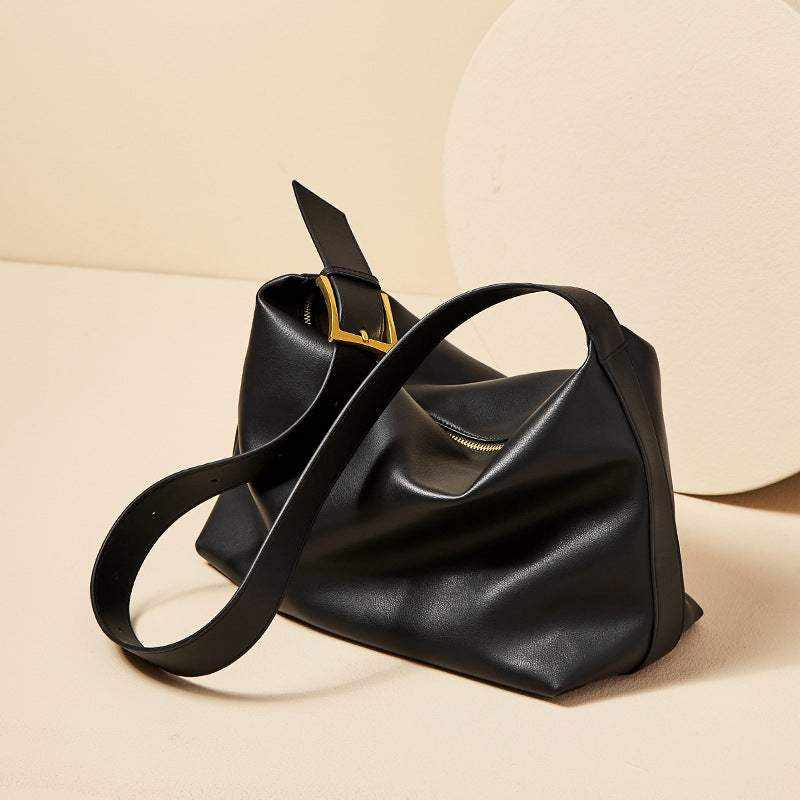 Black soft leather handbag with a modern unstructured silhouette, part of the Essence of Elegance Handbag Collection.