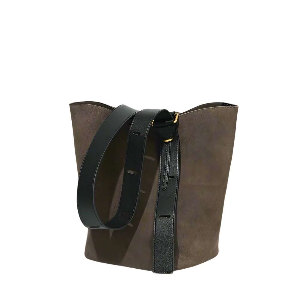 Suede bucket bag with black leather strap, spacious and durable design.