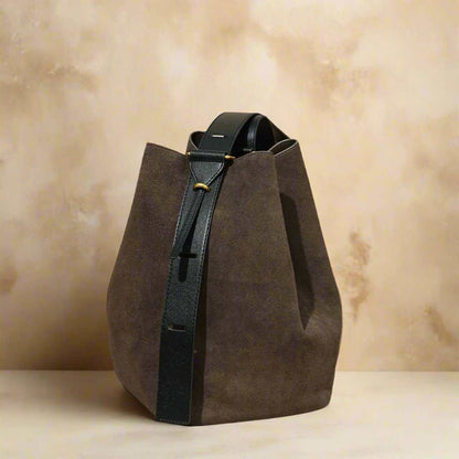 Versatile suede bucket bag with a convertible design and durable nubuck leather finish.