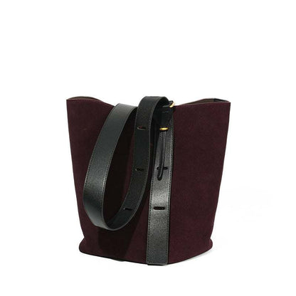 Elegant suede bucket bag with adjustable strap and durable design.