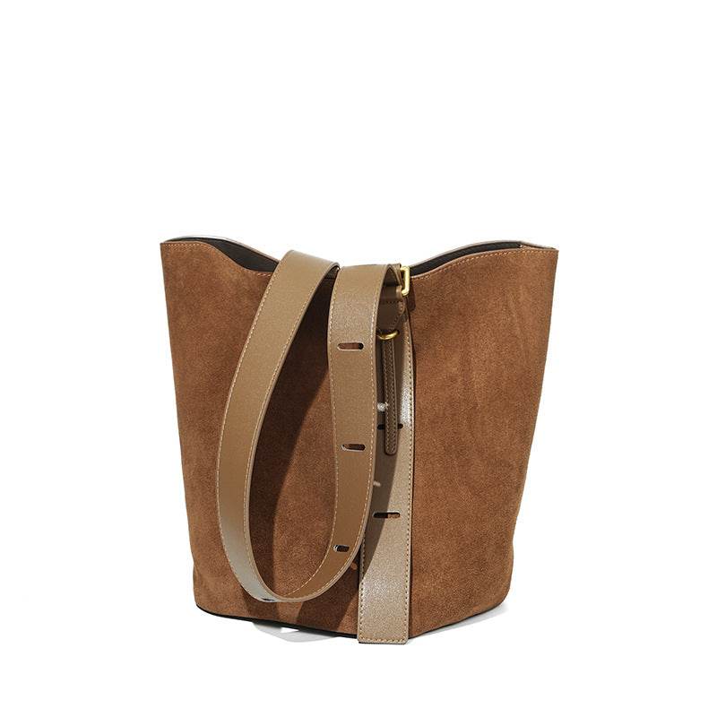 Suede bucket bag with adjustable strap and durable nubuck leather design.