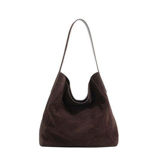 Brown suede slouch bag with a single shoulder strap and spacious design.