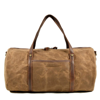 Waxed canvas duffle bag with leather handles and spacious design.