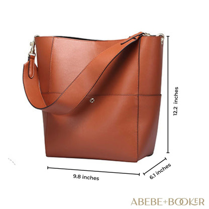 Women's bucket bag made of genuine leather with removable shoulder strap, spacious interior, and multiple pockets.