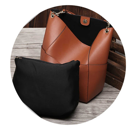 Genuine leather women's bucket bag with removable inner pouch, showcasing stylish design and practicality.