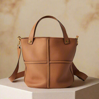 Women's leather work bag on display, featuring versatile strap and elegant design from the Leather Bucket Bags Collection.