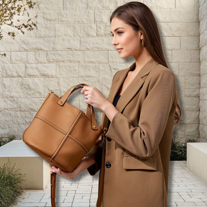 Woman holding a brown leather work bag, showcasing elegance and practicality for professionals.