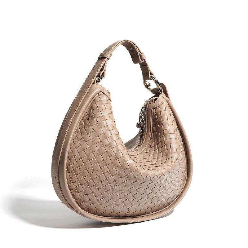 Woven leather crossbody bag in caramel color with adjustable straps and elegant design.