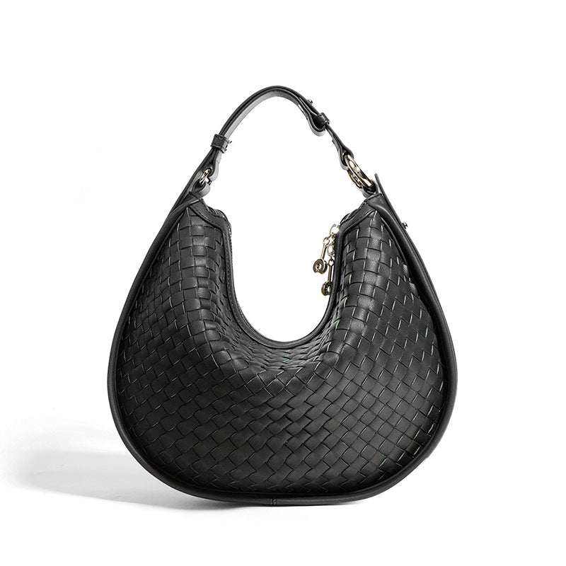 Woven leather crossbody bag with adjustable strap and sleek design.