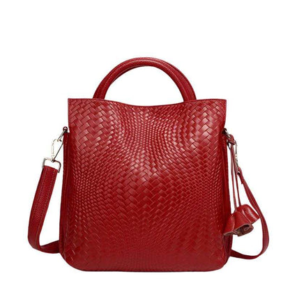 Red woven leather handbag with versatile design for shoulder or crossbody wear.