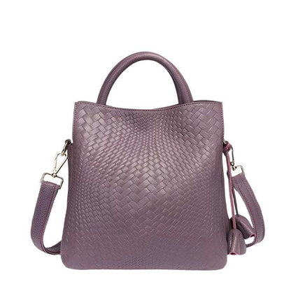 Woven Leather Handbag in mauve color with elegant pattern and adjustable strap.