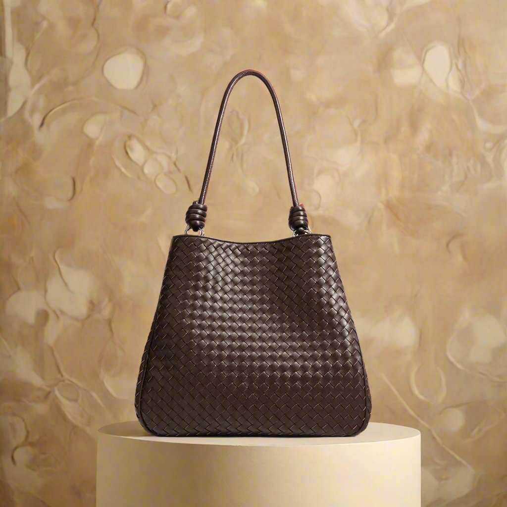 Woven Leather Tote Bag in basket weave design with unique leather rod handles, part of the Essence of Elegance Handbag Collection.