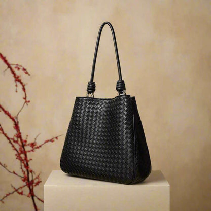 Woven Leather Tote Bag in black color with a basket weave design and leather rod handles.