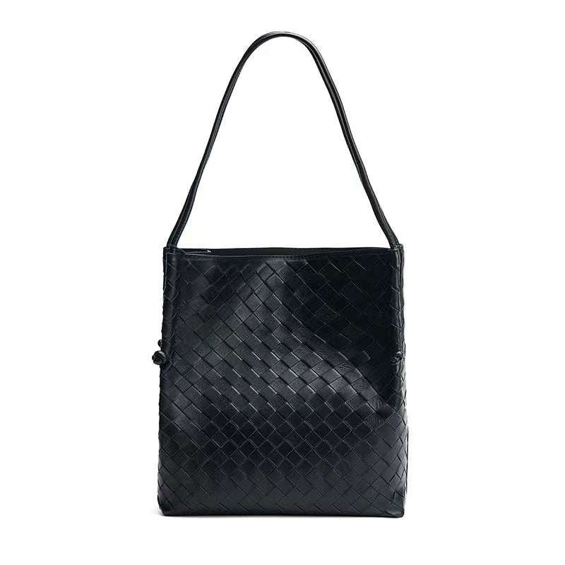 Black woven leather tote handbag with a spacious design and elegant craftsmanship.