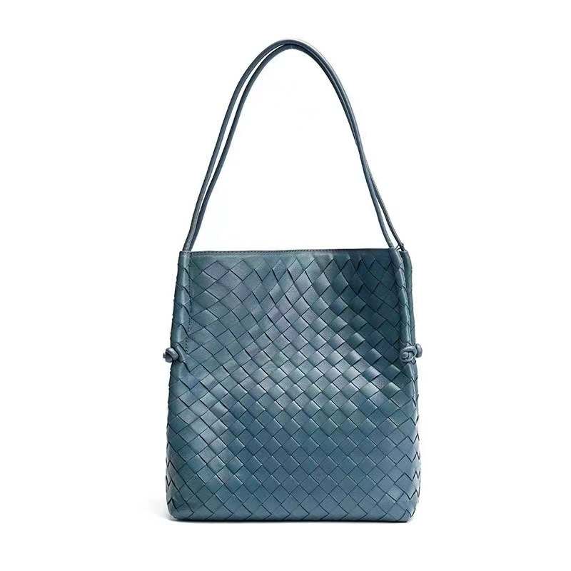 Woven Leather Tote Handbag in blue with embossed pattern and dual handles.