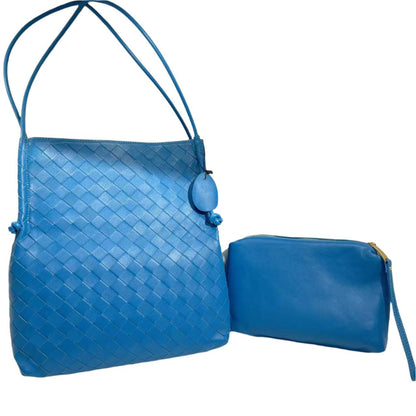 Woven Leather Tote Handbag in blue with removable interior bag and embossed pattern.