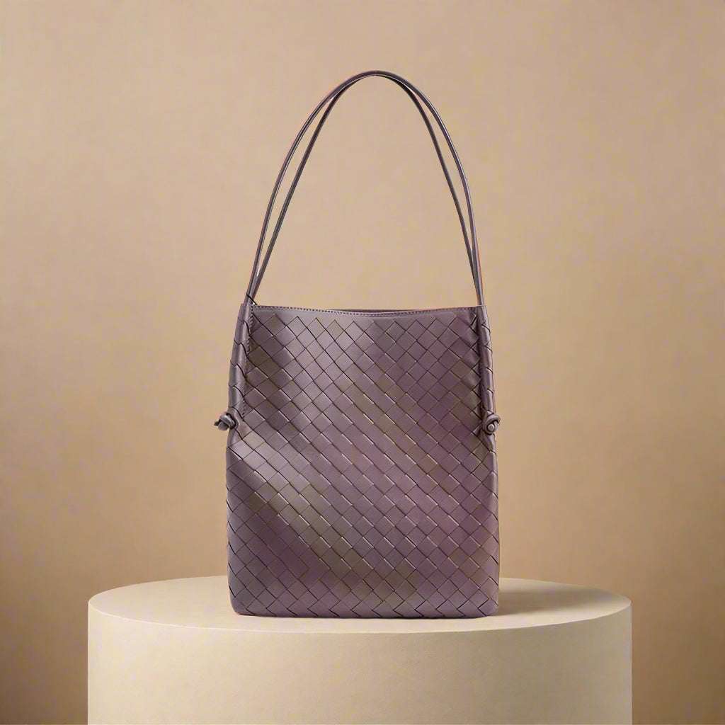 Woven leather tote handbag with elegant design, perfect for daily use.