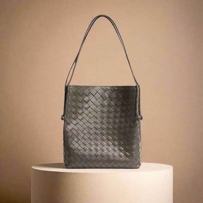 Woven Leather Tote Handbag with Embossed Pattern on Display Platform