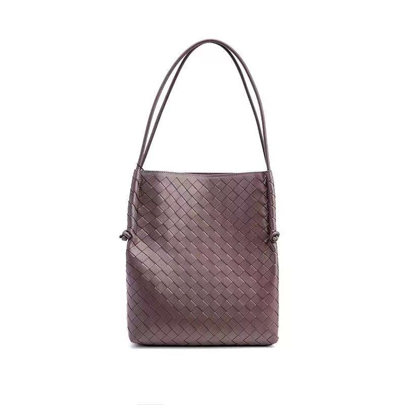 Woven Leather Tote Handbag with embossed pattern and dual straps.