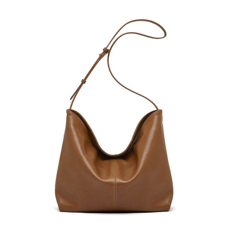 Slouchy leather purse in brown with adjustable shoulder strap.