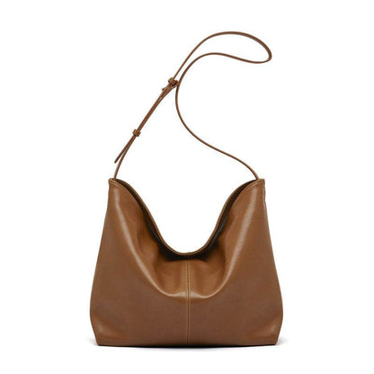 Slouchy leather purse in brown with adjustable shoulder strap.