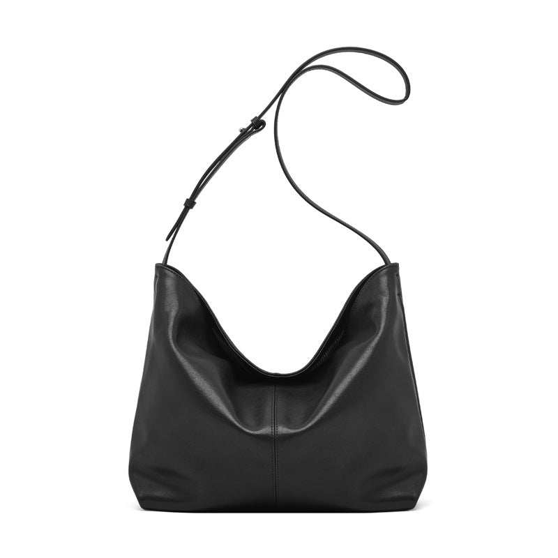 Slouchy leather purse with adjustable shoulder strap in black.